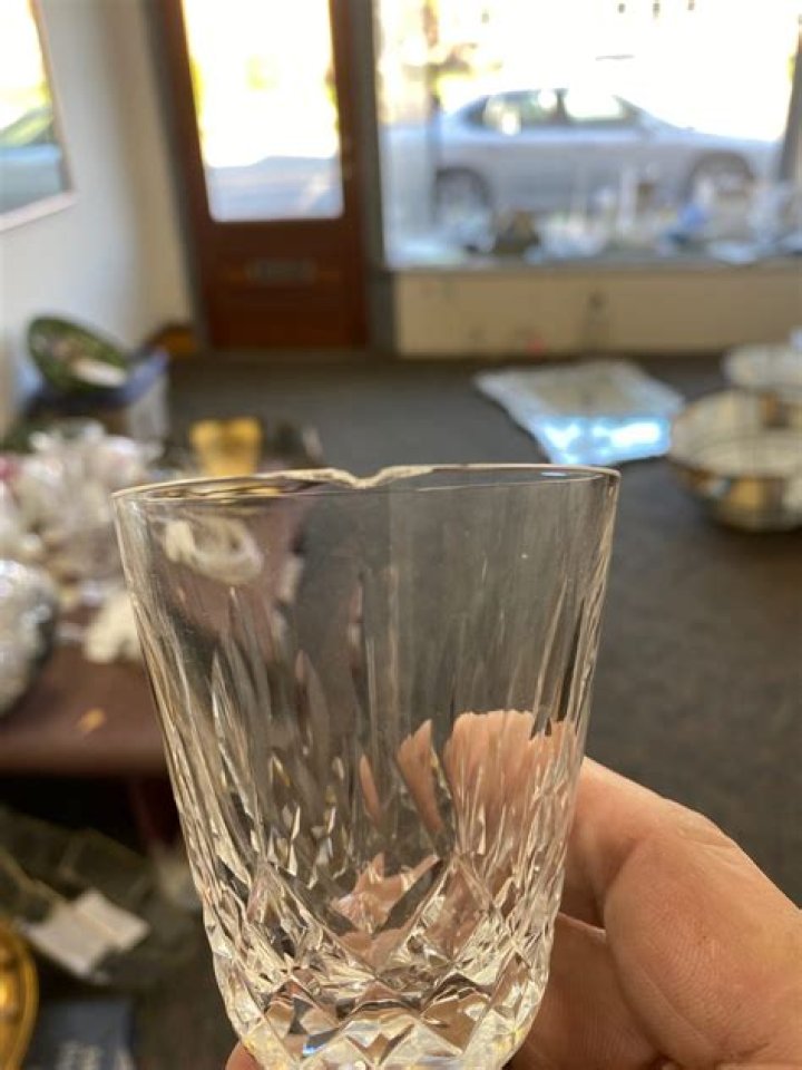 What should be done with chipped or cracked glassware?